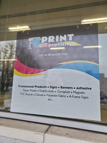 Custom perforated window film with Print With Provision branding, installed on storefront window for advertising and promotional display.
