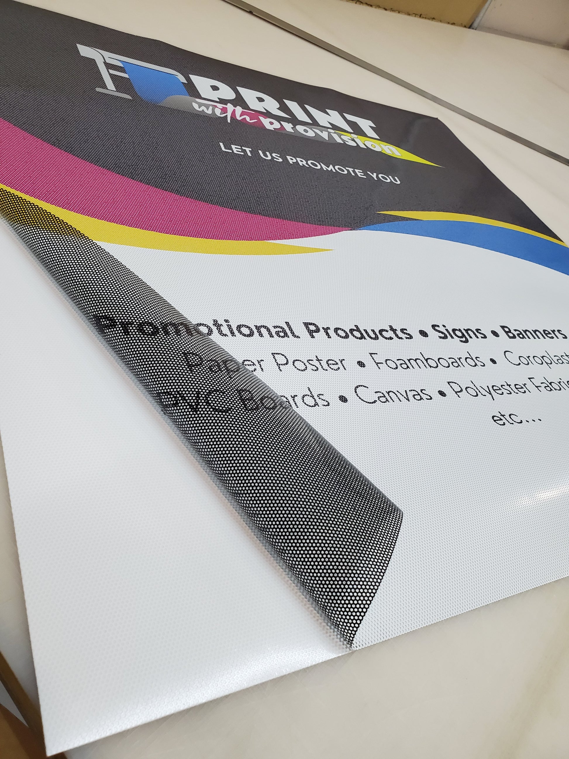 Custom perforated window film with Print With Provision branding, promotional sample showing see-through vinyl material for storefront advertising.
