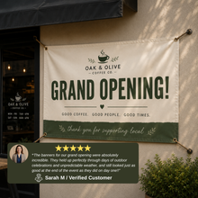 Outdoor vinyl banner displaying positive customer review for a small cafe grand opening, hung outside storefront entrance with durable weather-resistant print and vibrant professional design.