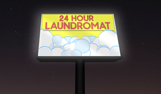 Backlit vinyl banner for 24 hour laundromat, illuminated sign with bubbles graphic, displayed at night for high visibility.
