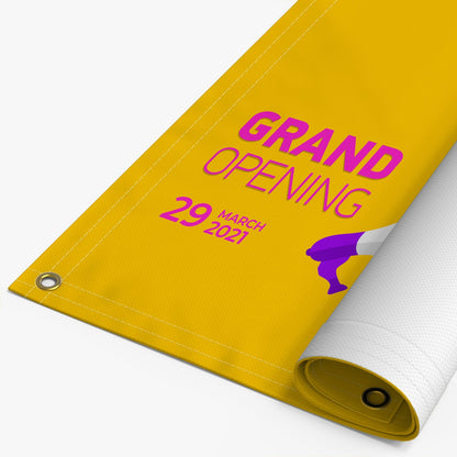 Custom yellow vinyl banner with grommets, grand opening design and rolled corner, example of personalized banner printing.