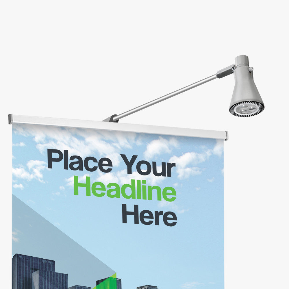 "Retractable banner stand with LED spotlight, pop up custom banner display with top-mounted lighting for enhanced visibility at trade shows and events.